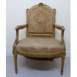 A 1920s French Louis XVI style, carved and gilded showwood framed, open arm chair with a high,