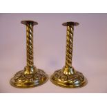 A pair of late 18th/early 19thC Scandinavian brass candlesticks, cast with floral and fruit designs,