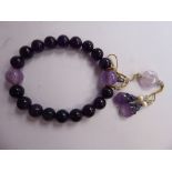 A Chinese amethyst coloured stone and seed pearl bead bracelet with pendants