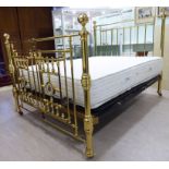 A modern reproduction of a late Victorian lacquered tubular brass framed bed with mother-of-pearl