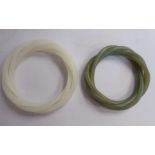 Two identical Chinese four-part, carved and entwined 'rope' bangles, one green,