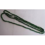A Chinese uniform small round seaweed green jade bead necklace