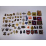 Approximately twenty five military cap badges, buttons,