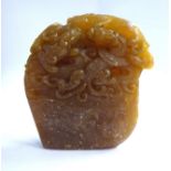 A late 19thC Chinese carved mottled brown soapstone seal of irregular form,