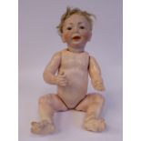 An early 20thC bisque head baby doll with painted features,