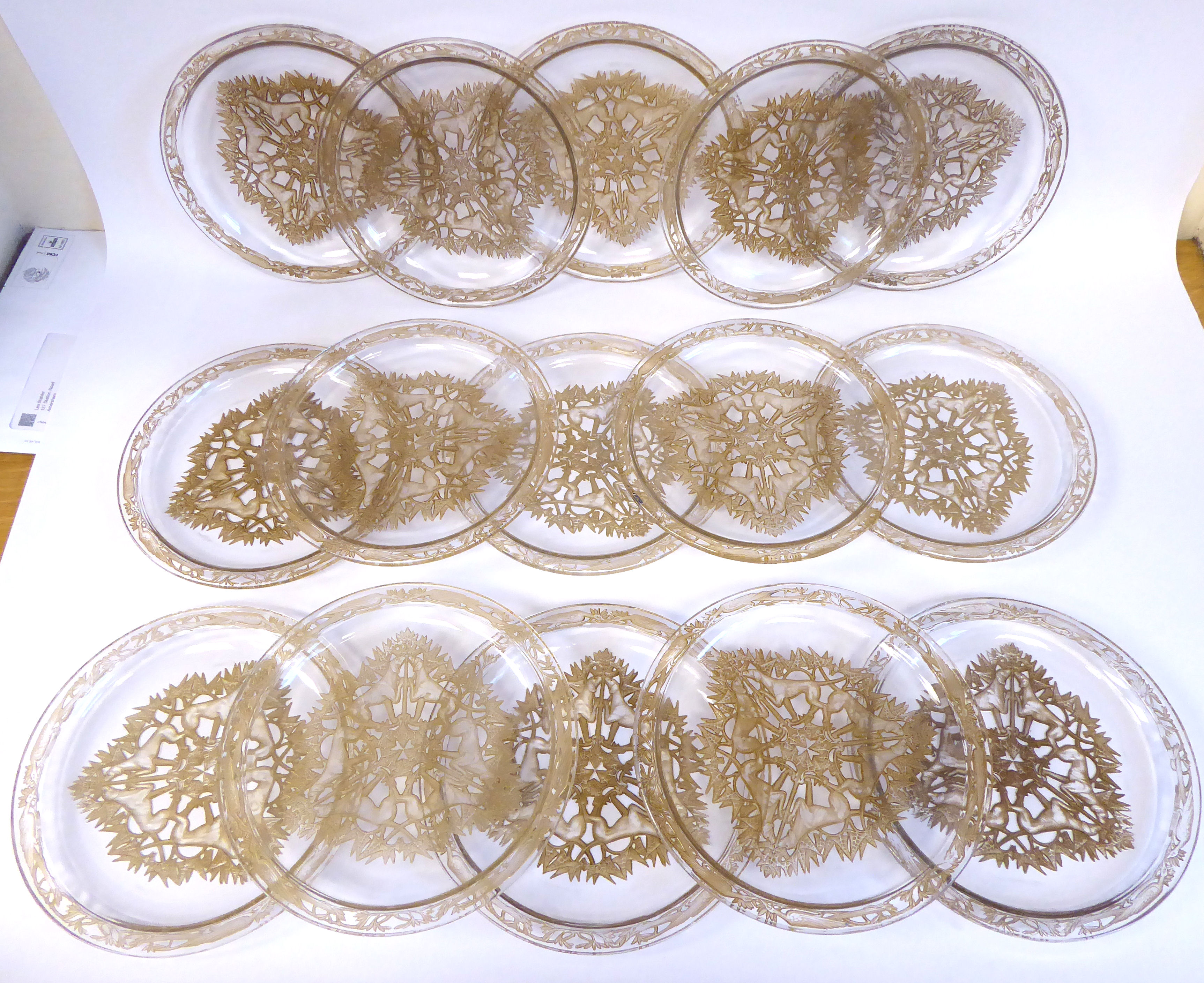 A set of fifteen Lalique Chase Chiens pattern glass plates, model 3001,