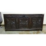 An 18thC dark stained and carved, panelled oak coffer with straight sides,