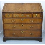 An early 18thC walnut bureau, the crossbanded border with a fall front, enclosing a fitted interior,