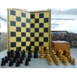 An early 20thC St George pattern turned and carved boxwood and rosewood chess set the kings 4''h