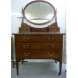 An Edwardian satinwood string inlaid mahogany dressing table, surmounted by an oval interior,