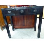 A modern Chinese black lacquered hall table, the top with a mitred edge with three frieze drawers,