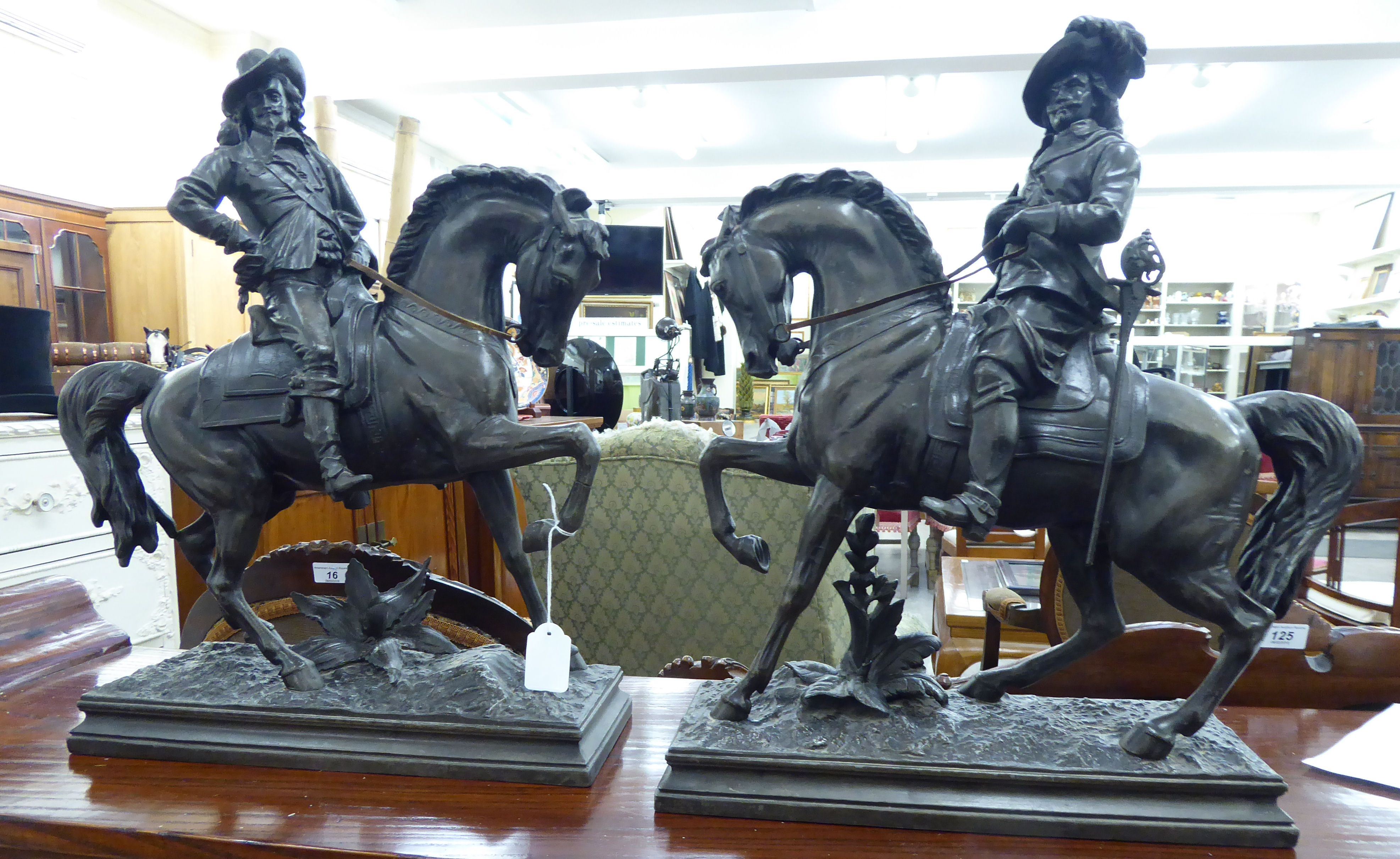 A pair of late 19th/early 20thC cast spelter figures, Cavaliers on horseback,