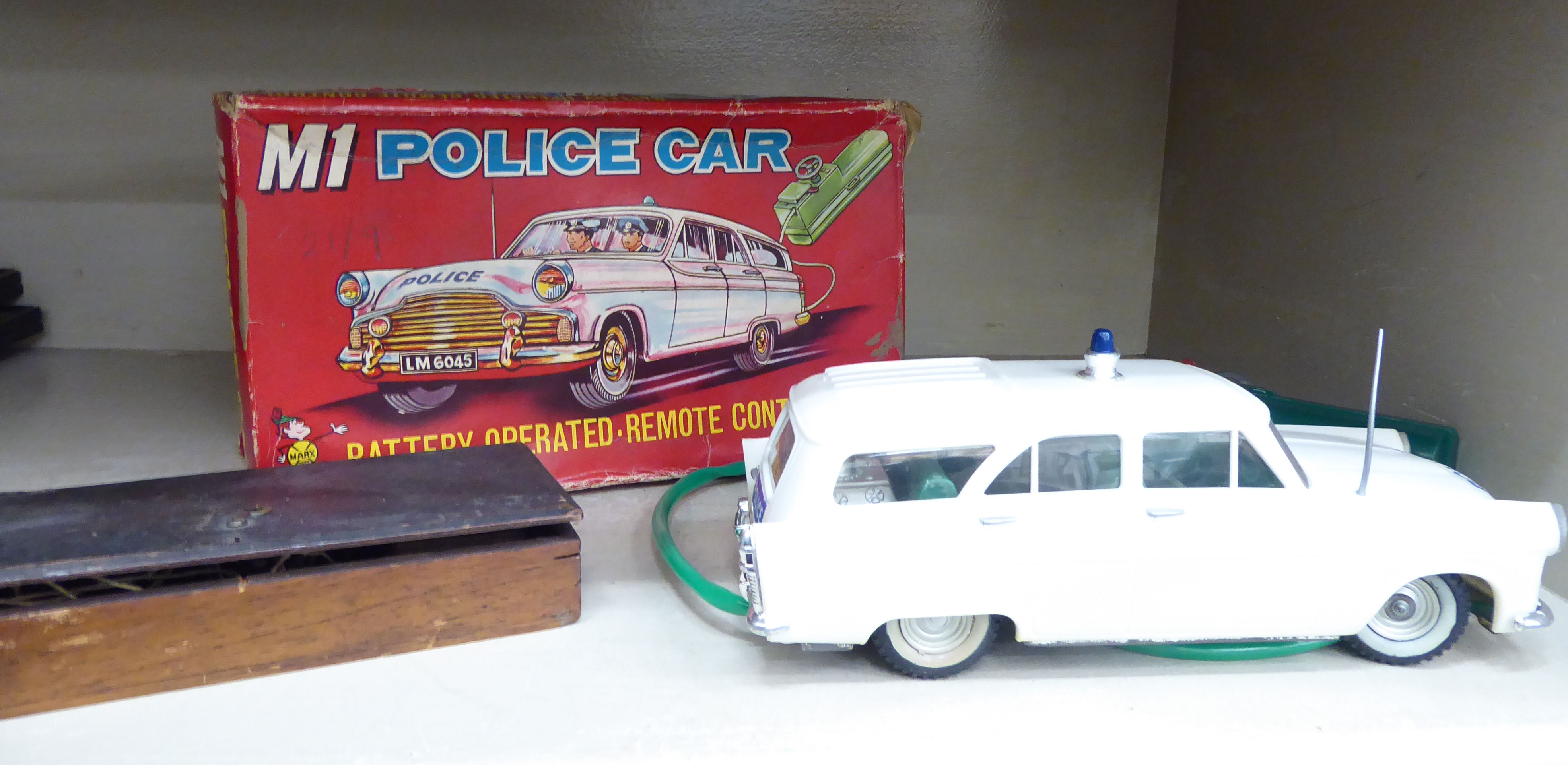 A 1960s Louis Marx Toys 'M1 Police Car' with a battery operated remote control,