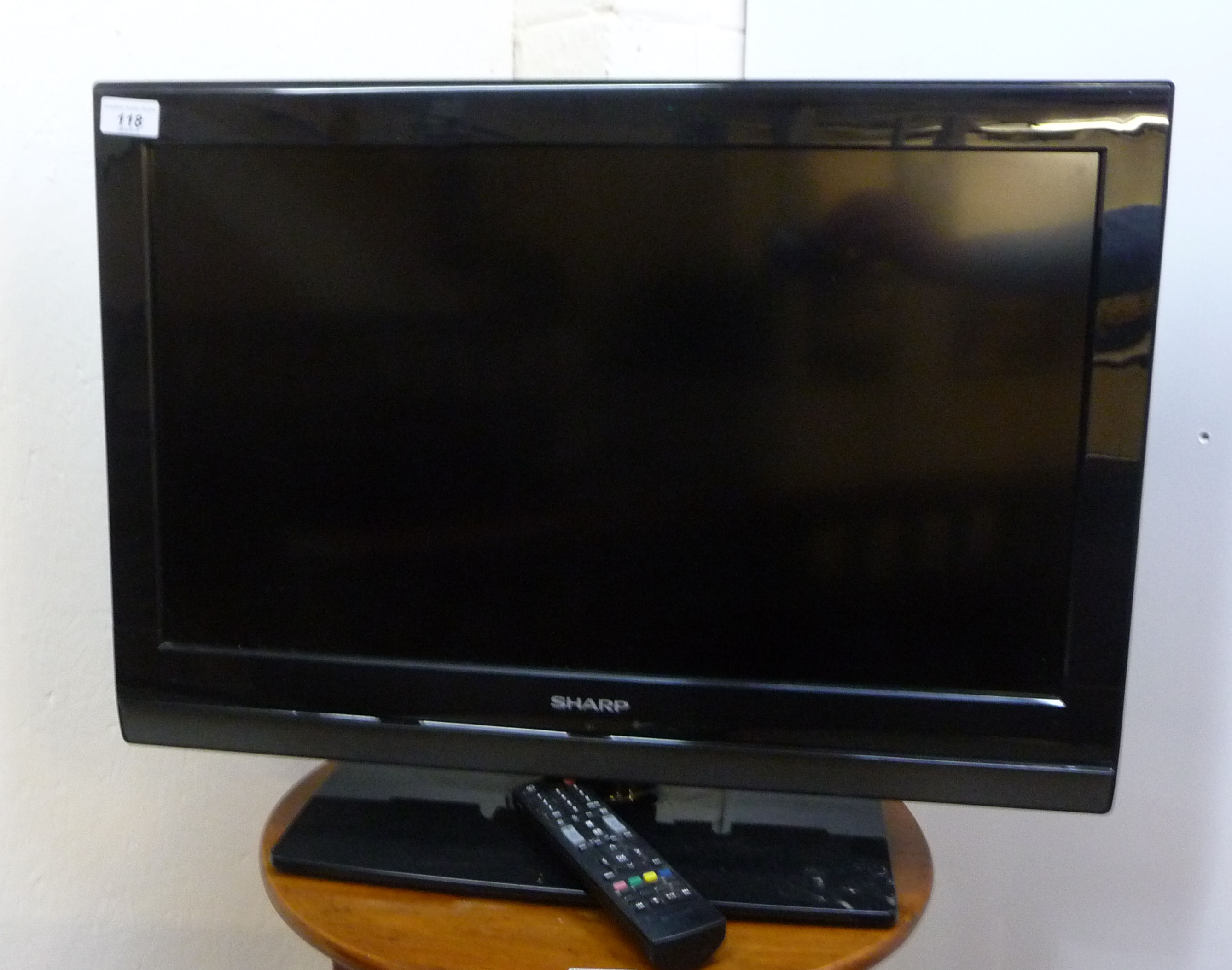 A Sharp 23'' television with a remote control BSR