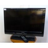 A Sharp 23'' television with a remote control BSR