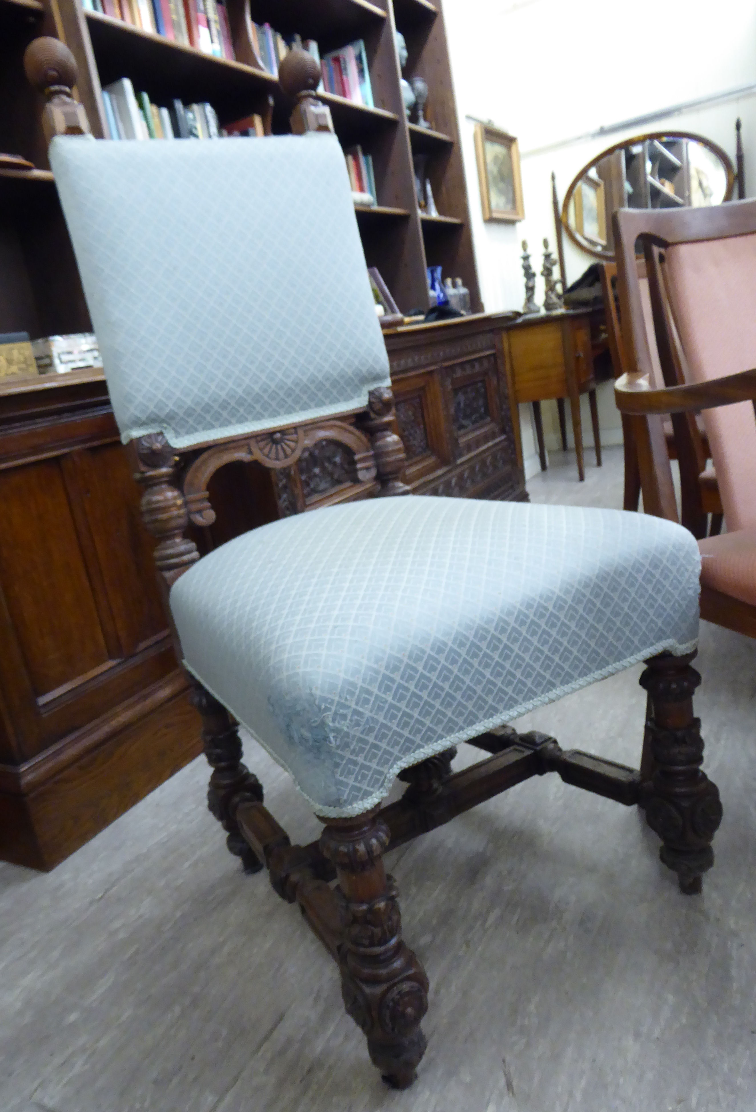 An early 20thC Colonial carved oak showwood framed hall chair,