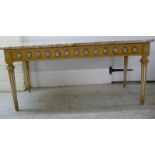 A modern 'antique' effect coffee table, the two tone marble top raised on gilded and white painted,