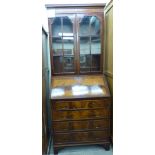 A modern Georgian style mahogany bureau bookcase with a dentil moulded cornice,