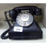 A mid 20thC black Bakelite cased cradle design telephone handset with a dial OS6