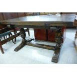 A 1930s Old English style stained oak, draw leaf refectory table, raised on substantial, twin,