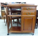 A modern Chinese fruitwood serving trolley with a removable tray top,