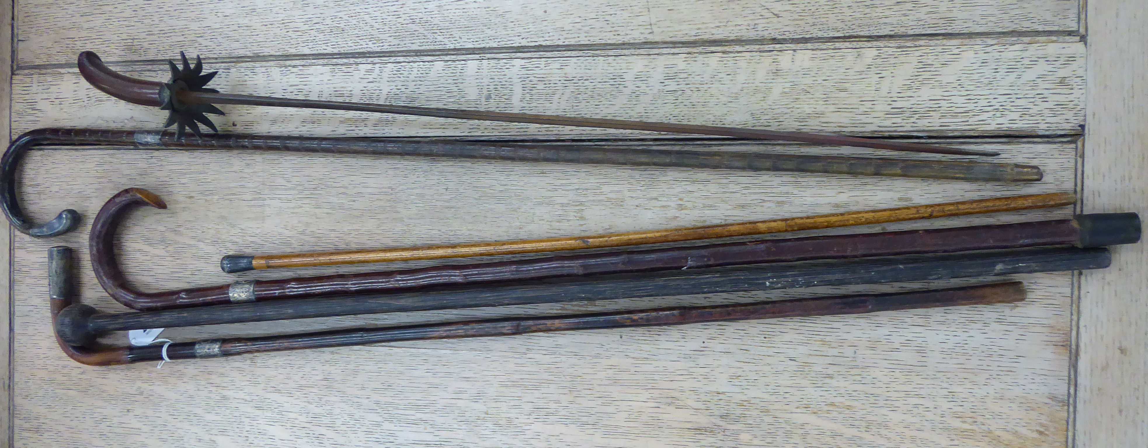 Six early 20thC walking sticks of varying designs,