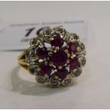 An 18ct gold ruby and diamond set cluster ring 11