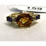 A 9ct gold ring, set with a central citrine,