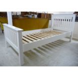 A modern white painted single bed frame,