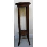 An Edwardian mahogany circular, two tier jardiniere stand,