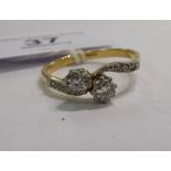 An 18ct gold two stone diamond ring,