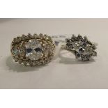 Two silver coloured metal dress rings,