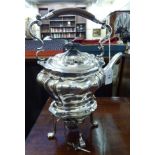 A late Victorian silver plated tea kettle of tapered, oval form with a fixed handle,