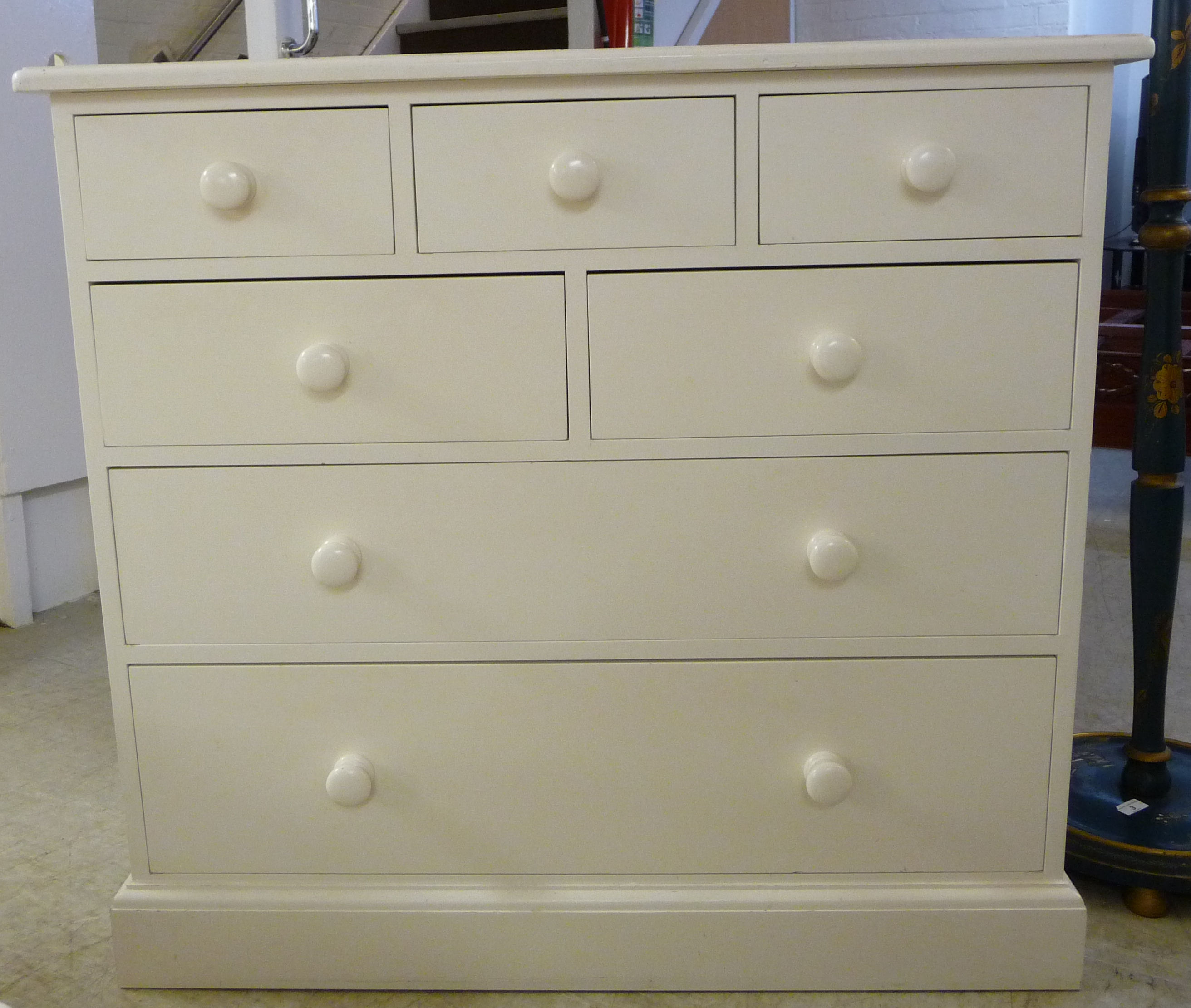 A modern white painted seven drawer dressing chest,