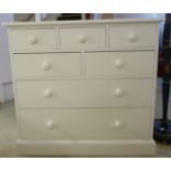 A modern white painted seven drawer dressing chest,