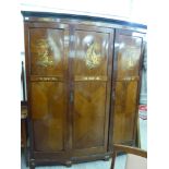 A 1930s/50s mahogany bow front wardrobe, enclosing an arrangement of shelves and rails,