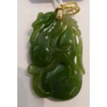 A Chinese carved jade pendant with a gold coloured metal loop 11