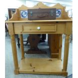 A modern Victorian style waxed pine washstand with a tiled splashback, over a central box drawer,