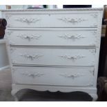 A 1950s French inspired white painted four drawer dressing chest,