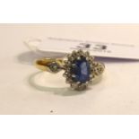 An 18ct gold claw set sapphire and diamond cluster ring 11