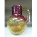 An early 20thC cranberry and amber coloured, semi-opaque,