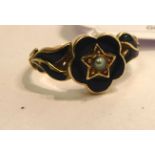 An 'antique' gold coloured metal and black enamel mourning ring,