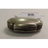 A silver coloured metal oval patch box with engine turned decoration stamped 925 11