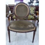 A modern French inspired carved, stained beech showwood framed salon chair,