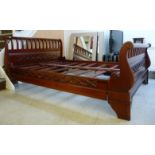 A modern, traditionally styled mahogany sleigh bed frame with scrolled,