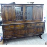 A modern Jacobean inspired oak dresser with pair of glazed doors,