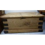 A late Victorian re-constituted pine chest with straight sides and a hinged lid,