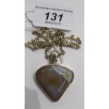 A gold coloured metal pendant, set with triangular shaped agate,