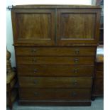 A mid 19thC mahogany linen chest with a pair of panelled doors, over five graduated drawers,