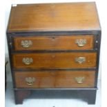 An Edwardian string inlaid and crossbanded mahogany bureau with three long drawers,